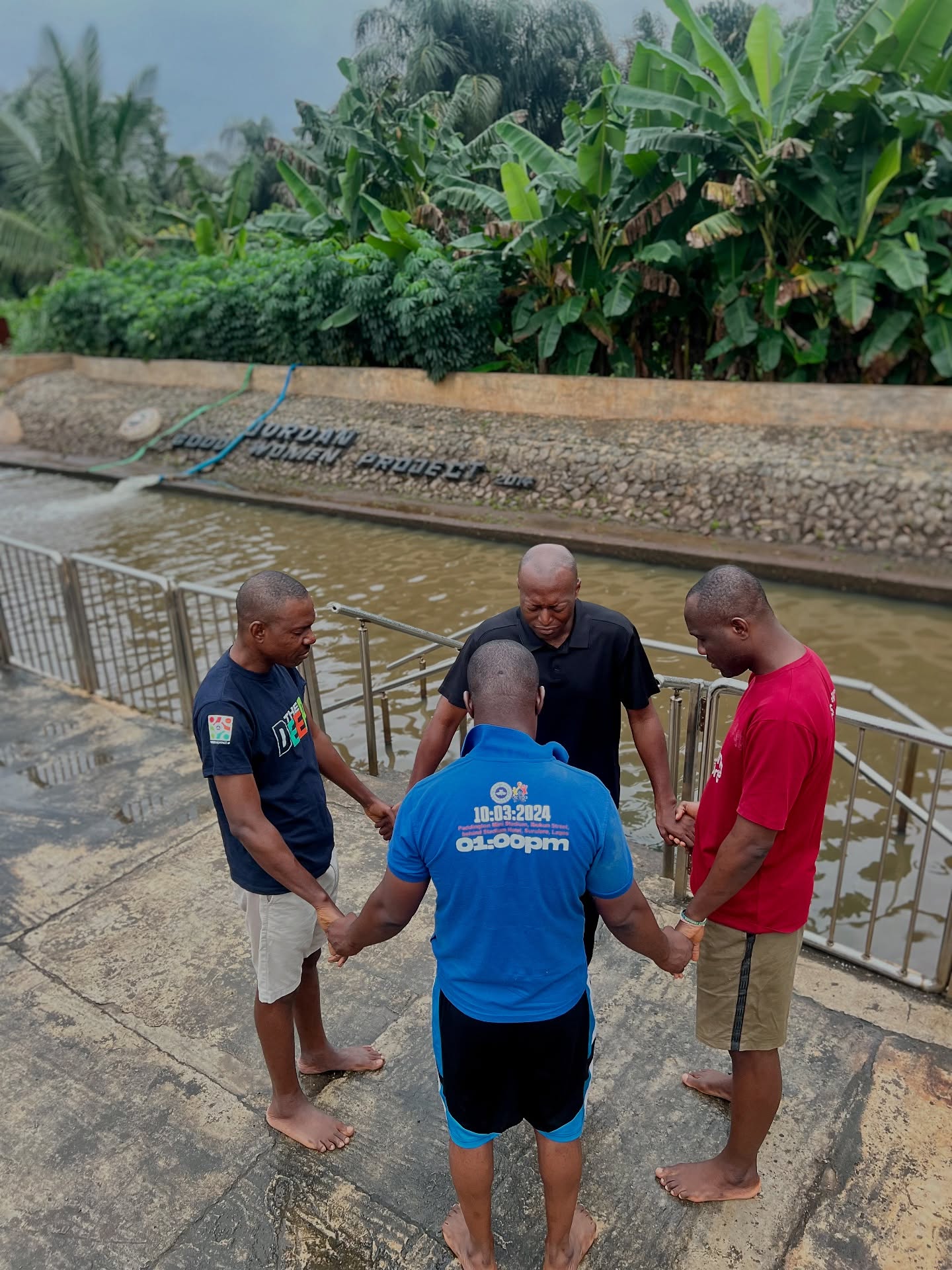 Men praying at the water